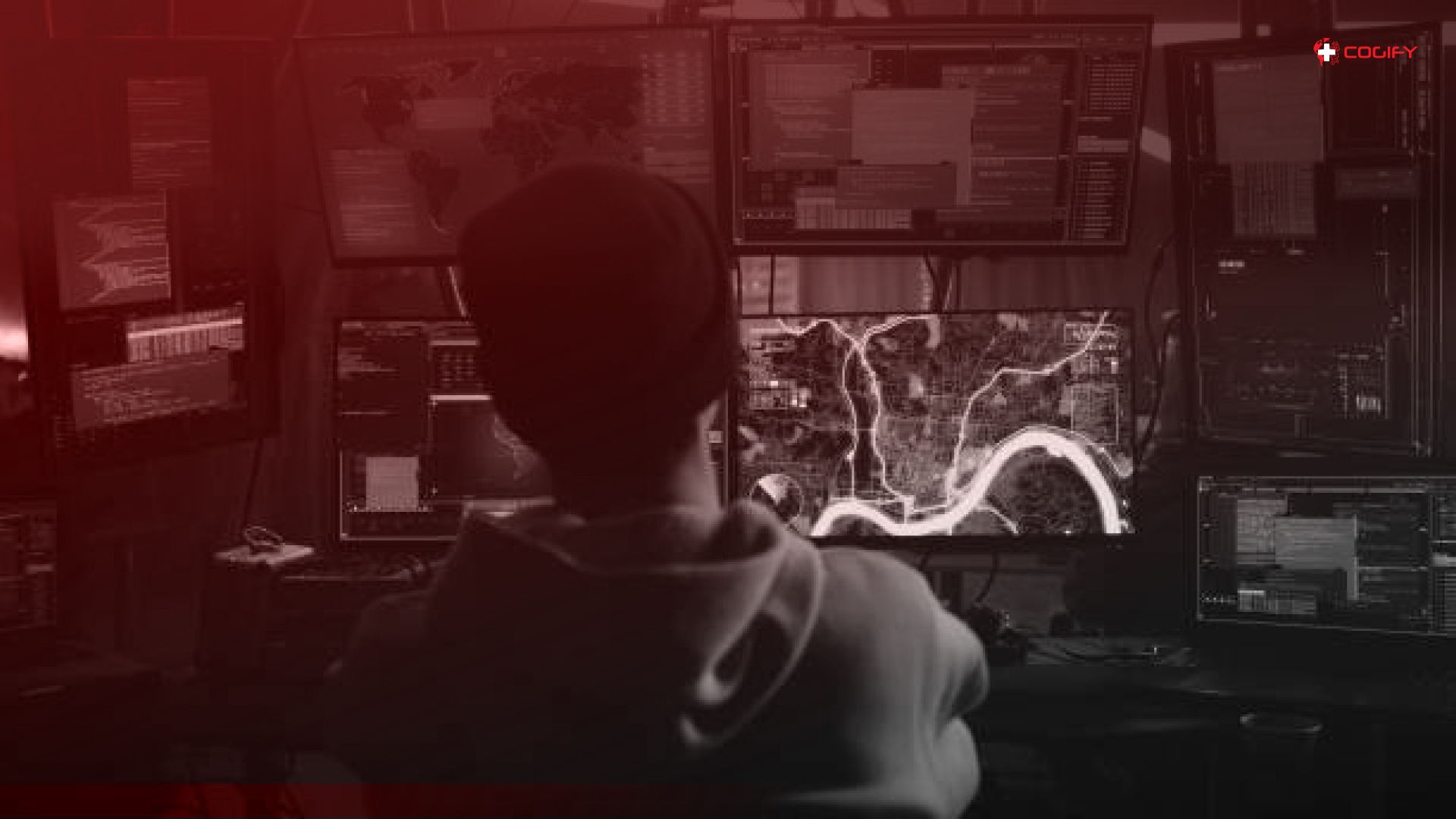 A person working on a computer showing from their behind.